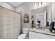 Clean bathroom with vanity and mirror, toilet, and tub/shower with a neutral curtain at 1824 Saddlewood Cir, Port Charlotte, FL 33953