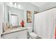 Fresh bathroom includes a granite vanity, a toilet, and a shower/tub with a white shower curtain at 1824 Saddlewood Cir, Port Charlotte, FL 33953