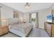 Bedroom featuring a large bed, dresser with a TV, and a window with backyard views at 1824 Saddlewood Cir, Port Charlotte, FL 33953