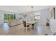 Dining area open to living room with modern chandelier and sliding glass doors to backyard at 1824 Saddlewood Cir, Port Charlotte, FL 33953