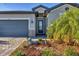 Beautifully landscaped front yard with stone accents, mature palms, and decorative animal statues at 1824 Saddlewood Cir, Port Charlotte, FL 33953