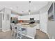 Bright kitchen with white cabinets, stainless steel appliances, granite countertops, and island with seating at 1824 Saddlewood Cir, Port Charlotte, FL 33953