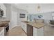 Eat-in kitchen with white cabinets, stainless steel appliances, granite countertops, and island at 1824 Saddlewood Cir, Port Charlotte, FL 33953