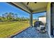 Relaxing covered patio with outdoor seating and views of the serene backyard and landscaping at 1824 Saddlewood Cir, Port Charlotte, FL 33953