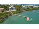 Stunning waterfront property featuring a private dock, pool, and lush landscaping at 19 Grouper Hole Dr, Boca Grande, FL 33921