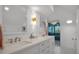 Bright bathroom featuring double vanity with white cabinets, quartz counters, and a modern tiled glass shower at 19 Grouper Hole Dr, Boca Grande, FL 33921