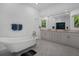 Bright bathroom features soaking tub, marble floors, and double vanity with great storage at 19 Grouper Hole Dr, Boca Grande, FL 33921
