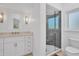 Bathroom featuring frameless glass shower door, stone countertops, and vanity storage at 19 Grouper Hole Dr, Boca Grande, FL 33921