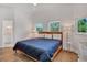 Bedroom with hardwood flooring, blue comforter on the bed, and great natural light at 19 Grouper Hole Dr, Boca Grande, FL 33921