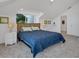 Bedroom featuring neutral carpeting, a ceiling fan, a bed with cozy bedding, and bright, natural light at 19 Grouper Hole Dr, Boca Grande, FL 33921