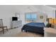 Cozy bedroom with a large bed, white dresser, and sliding doors that let in ample natural light at 19 Grouper Hole Dr, Boca Grande, FL 33921