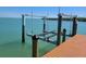 Exterior view showing a private boat lift on the water, adjacent to a wooden dock at 19 Grouper Hole Dr, Boca Grande, FL 33921