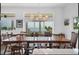 Bright dining area with waterfront views, wood table, and modern chandelier lighting at 19 Grouper Hole Dr, Boca Grande, FL 33921