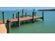 Dock showing wood planking with multiple pilings along calm waters at 19 Grouper Hole Dr, Boca Grande, FL 33921