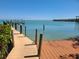 View of the dock with composite wood and a clear waterway in the distance at 19 Grouper Hole Dr, Boca Grande, FL 33921