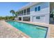 Exterior view of home, showing in-ground pool, screened porch, and multi-level design at 19 Grouper Hole Dr, Boca Grande, FL 33921