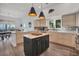 Spacious modern kitchen with custom cabinets, an island, stainless steel appliances and water views at 19 Grouper Hole Dr, Boca Grande, FL 33921