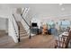 Bright and airy living room with a staircase, hardwood floors, and water views at 19 Grouper Hole Dr, Boca Grande, FL 33921