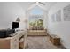 Bright office featuring a desk, seating, a sofa and ample natural light streaming through a large arched window at 19 Grouper Hole Dr, Boca Grande, FL 33921