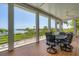 Screened patio featuring a dark metal table and chairs, ceiling fan, and stunning waterfront views at 19 Grouper Hole Dr, Boca Grande, FL 33921