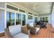 Inviting outdoor patio with comfortable seating and expansive sliding glass doors at 19 Grouper Hole Dr, Boca Grande, FL 33921