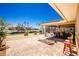 Beautiful brick patio with lounge chairs, colorful seating and an outdoor dining area overlooking the canal at 1957 Arkansas Ave, Englewood, FL 34224