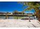 Waterfront backyard with a private dock, canal access, and tropical landscaping for ultimate outdoor enjoyment at 1957 Arkansas Ave, Englewood, FL 34224
