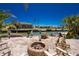 Waterfront backyard features a fire pit, tiki decor, and tropical landscaping with scenic canal views at 1957 Arkansas Ave, Englewood, FL 34224