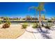 Landscaped backyard featuring a canal view, palm trees, and a well-maintained walkway leading to the waterfront at 1957 Arkansas Ave, Englewood, FL 34224