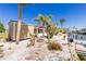 Spacious backyard featuring canal access, a dock, shed, and a cozy fire pit area at 1957 Arkansas Ave, Englewood, FL 34224