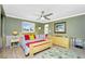 Bedroom with ceiling fan and large window at 1957 Arkansas Ave, Englewood, FL 34224