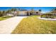 Charming single-story home with a brick driveway, garage and mature landscaping at 1957 Arkansas Ave, Englewood, FL 34224