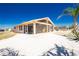 Exterior view of the home showcasing a screened-in patio and a well-maintained yard at 1957 Arkansas Ave, Englewood, FL 34224