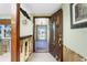 Open entryway with tiled floor and beautiful wood front door at 1957 Arkansas Ave, Englewood, FL 34224