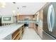 Bright kitchen features stainless appliances, granite countertops, and an island with open shelving at 1957 Arkansas Ave, Englewood, FL 34224