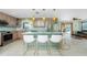 Modern kitchen features a central island with bar seating and stainless appliances at 1957 Arkansas Ave, Englewood, FL 34224