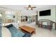 Open-concept living room with a TV, ceiling fan, and tiled floors at 1957 Arkansas Ave, Englewood, FL 34224