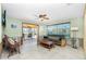 Cozy living area with tile floors, ceiling fan, and outdoor views at 1957 Arkansas Ave, Englewood, FL 34224