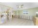 Open-concept living room featuring tile flooring and multiple windows at 1957 Arkansas Ave, Englewood, FL 34224
