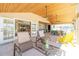 Inviting outdoor patio with lounge chairs, dining area, outdoor kitchen and ceiling fans at 1957 Arkansas Ave, Englewood, FL 34224