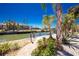 Waterfront canal view with mature landscaping, stone walkway, and scenic backyard at 1957 Arkansas Ave, Englewood, FL 34224