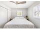 Bedroom with wood floors, neutral colors, natural light from the windows, and a ceiling fan at 2105 Arkansas Ave, Englewood, FL 34224