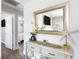 Entryway featuring a mirror, console table, and wood floors, flowing into the living room and bedroom at 2105 Arkansas Ave, Englewood, FL 34224