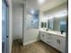 Modern bathroom featuring double vanity, walk-in shower and decorative mirror at 220 Jennifer Dr, Rotonda West, FL 33947