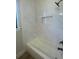 Bathroom showcasing a tiled shower and bathtub featuring a built-in niche for toiletries at 220 Jennifer Dr, Rotonda West, FL 33947