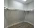 Walk-in closet with metal shelving and hardwood floors at 220 Jennifer Dr, Rotonda West, FL 33947