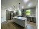 Modern kitchen with stainless steel appliances and a large center island at 220 Jennifer Dr, Rotonda West, FL 33947