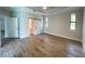 Spacious main bedroom featuring wood flooring and a sliding barn door at 220 Jennifer Dr, Rotonda West, FL 33947