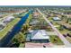 Aerial view of the home highlighting the pool, screened lanai, waterfront location and landscaping at 228 White Marsh Ln, Rotonda West, FL 33947