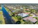 Aerial view of waterfront property with pool, lush landscaping, and serene setting at 228 White Marsh Ln, Rotonda West, FL 33947